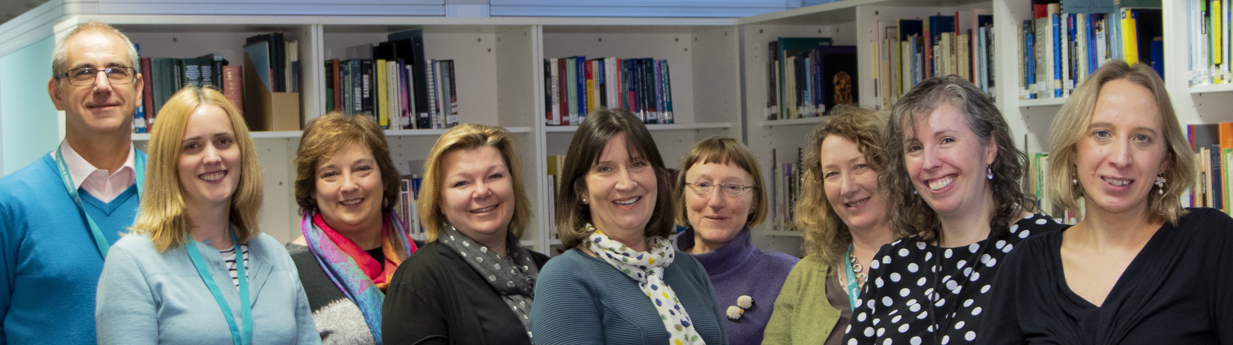 SHINE team in front of bookshelves